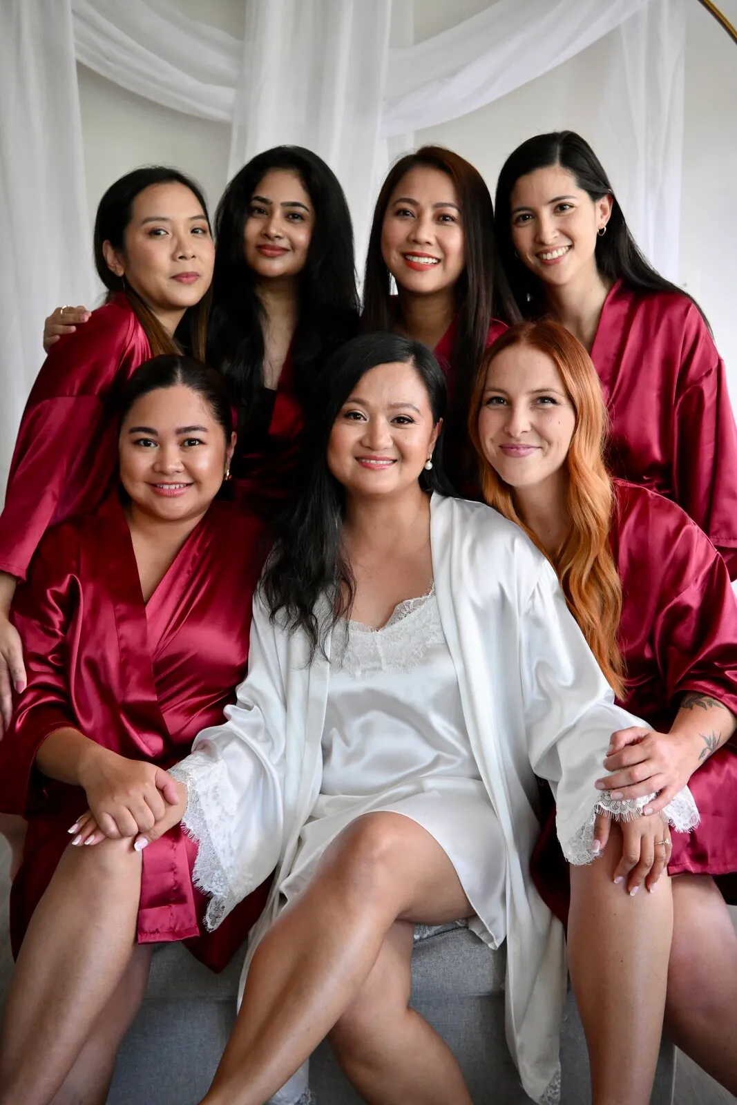 Bride and bridesmaids in matching robes on the wedding morning